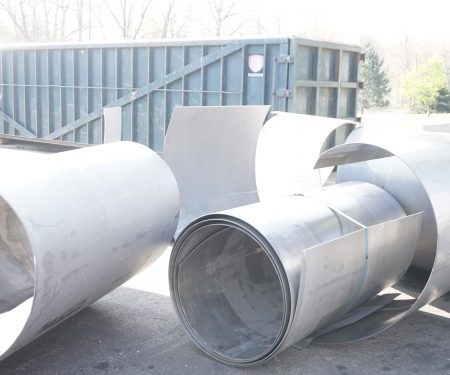 rolls of recycled steel in a scrap metal yard