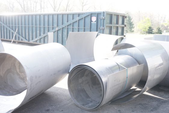 rolls of recycled steel in a scrap metal yard